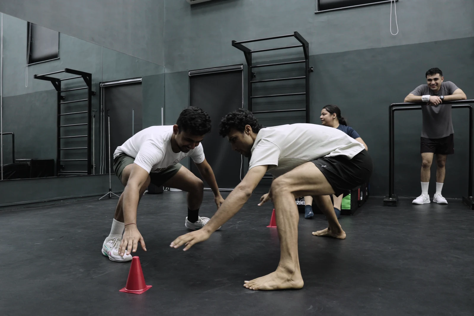 Players reaching for a cone during a partner reaction game at BAY.