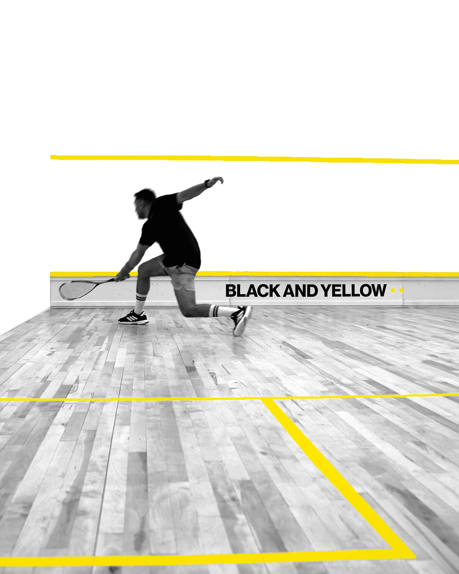 A squash player lunging for a forehand beside the BLACK AND YELLOW tin, in black and white with bright BAY yellow court markings and dots.