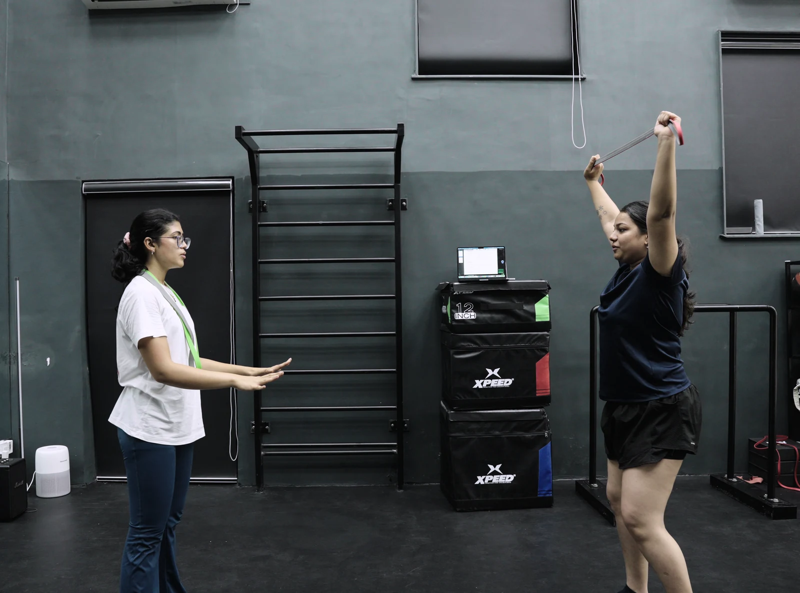 A coach watching a player perform an overhead movement at BAY.